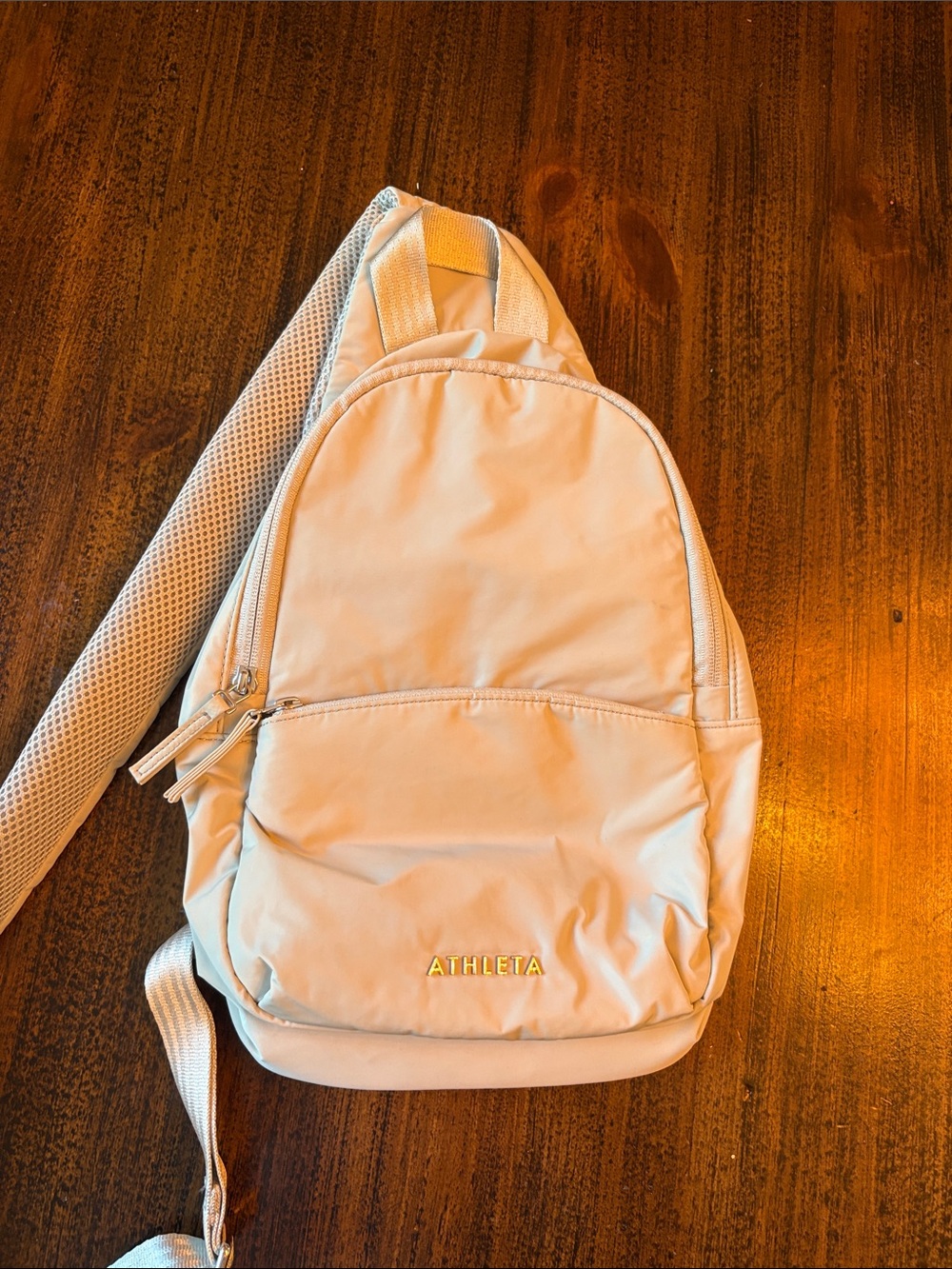 Athleta Cream Sling Over the Shoulder Backpack with Gold Logo
